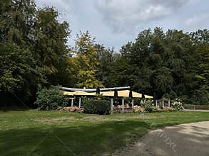 Green Grass Field with Park Cafe and Walking Path in Amsterdam Forest