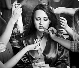 Fashion models prepared for runway by stylish designer. Black and white photography