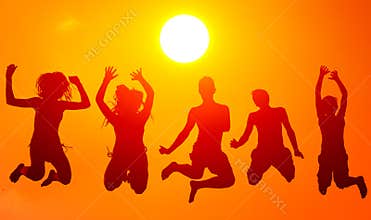 Silhouettes of teenage boys and girls jumping high in the air on