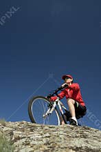 The woman on mountain bicycle