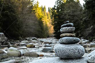 Zen stones stacked on river scene