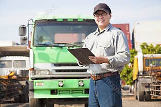Happy truck driver writing on document