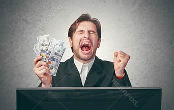 Happy businessman with money in hand and computer