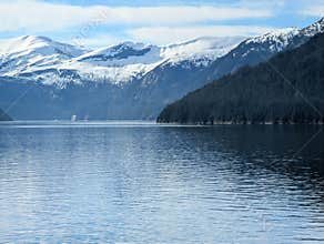 Endicott Arm landscape with snowy mountains and a cruise ship