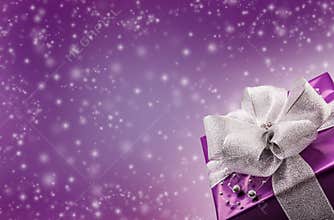 Christmas or Valentine's purple gift with silver ribbon abstract purple background