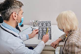 Doctor shows to a patient a CT scan of her lungs. Pneumonia, coronavirus, lung disease