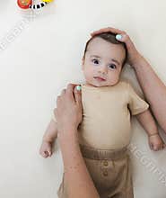 Torticollis in infants. Physiotherapist performs examination to diagnose wryneck in child, performs stretching