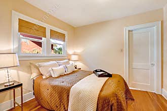 Warm bedroom interior with brown bedding and ivory blanket