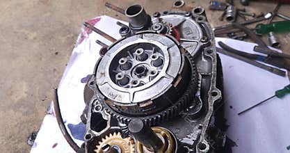 Mechanic Repairing Motorcycle Engine Clutch Assembly
