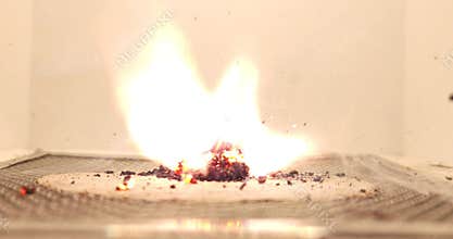 Close-up of the exothermic redox reaction between potassium permanganate and glycerin