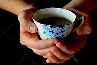 Hands Holding Cup of Tea