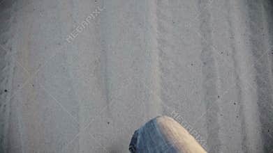Man Walking in sand barefoot