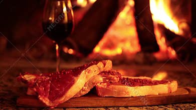 Raw Beef Steaks In Front Of Fireplace