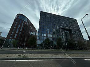 Street level view of modern high rise office towers along roadway in