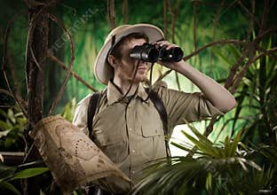 Explorer in the jungle with binoculars