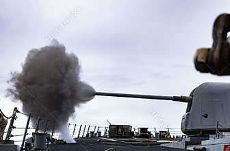 .U.S. Navy Arleigh Burke-class guided-missile destroyer USS Benfold (DDG 65) fires its Mark 38 Mod II 25-mm machine gun