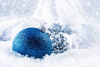 Luxury blue Christmas ball with ornaments in Christmas Snowy Landscape.