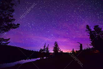 Purple Stary Night Sky Over Forest and Lake