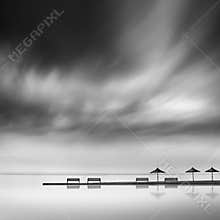 Pier with umbrellas and benches