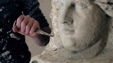 Sculptor is working on the creation of a monument