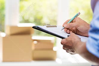 Logistics - delivery service man writing documents