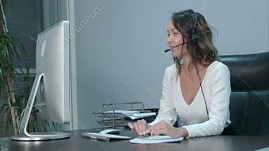 Young asian operator talking with customer in international call center