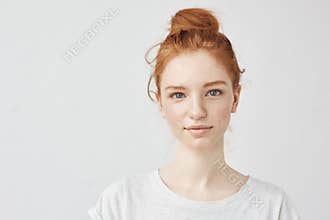 Portrait of beautiful redhead girl smiling looking at camera.