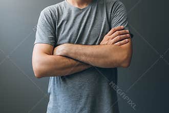 Casual adult man with arms crossed, body language