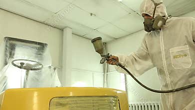Loader being painted and varnished in a painting chamber, Spraying a cars