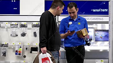 Motion of people buying new digital camera lens