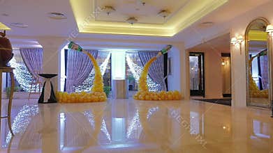 The design of a hall in the yellow balloons. Bunch of colored balloon decoration. Yellow background.