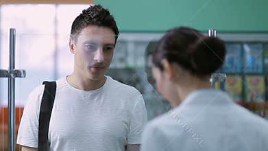Young male customer buying medicine at pharmacy