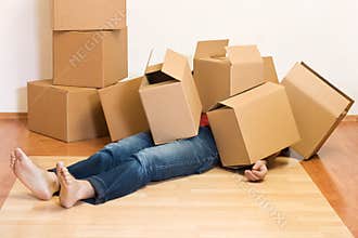 Man covered in cardboard boxes - moving concept