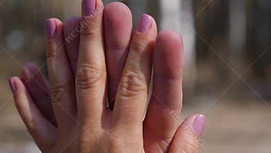 Closeup of two Lovers Joining Hands. Detail Silhouette of Man and Woman holding hands over. Love and Happiness concept.