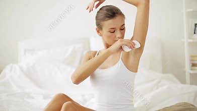 Woman with antiperspirant deodorant at home