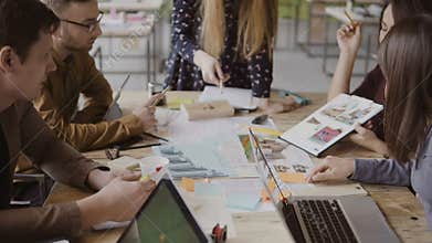 Young creative business team in modern office. Multiethnic group of people working on architectural design together.