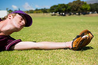 Baseball pitcher catching ball while diving on field