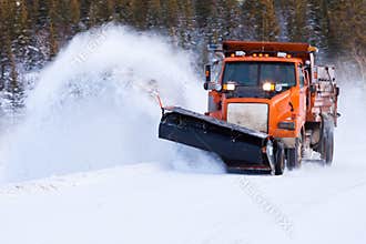 Snow plow clearing road after winter snow storm
