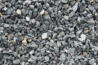 Aggregate of coarse gray stones, crushed at a stone pit, gravel pattern