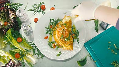 The cook pour the oil on omelet