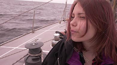 Young girl on a boat enjoys fresh sea air 4K UHD slowmo