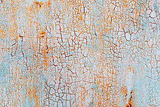 Abstract blue orange texture with grunge cracks. Cracked paint on a metal surface