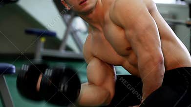 Young athletic man execute muscle exercises