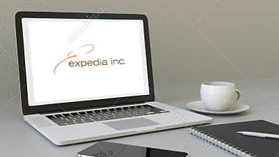 Opening laptop with Expedia logo on the screen. Modern workplace conceptual editorial 4K clip