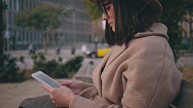Girl with electronic book reader on street