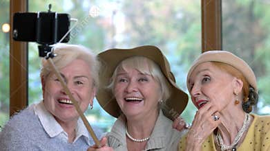 Three senior women taking selfie.
