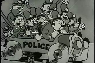 Wide shot policemen in car waving billy clubs