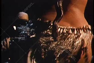 Belly dancer dancing with snake wrapped around her