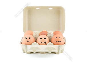 Funny Drawing Faces on Eggs in carton isolate on white with clip