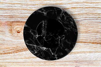 Black marble plate placed on wood.